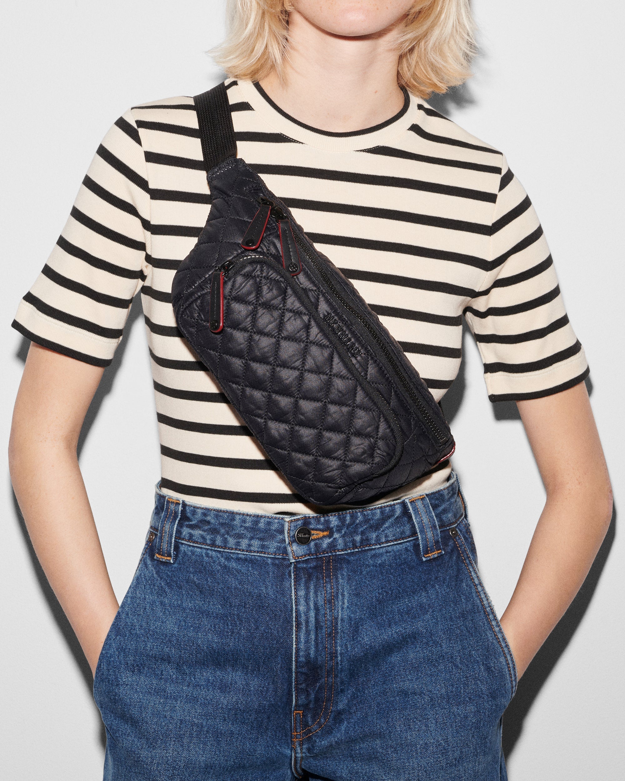 Model wearing Black Metro Sling - Black Crossbody Sling Bag across chest