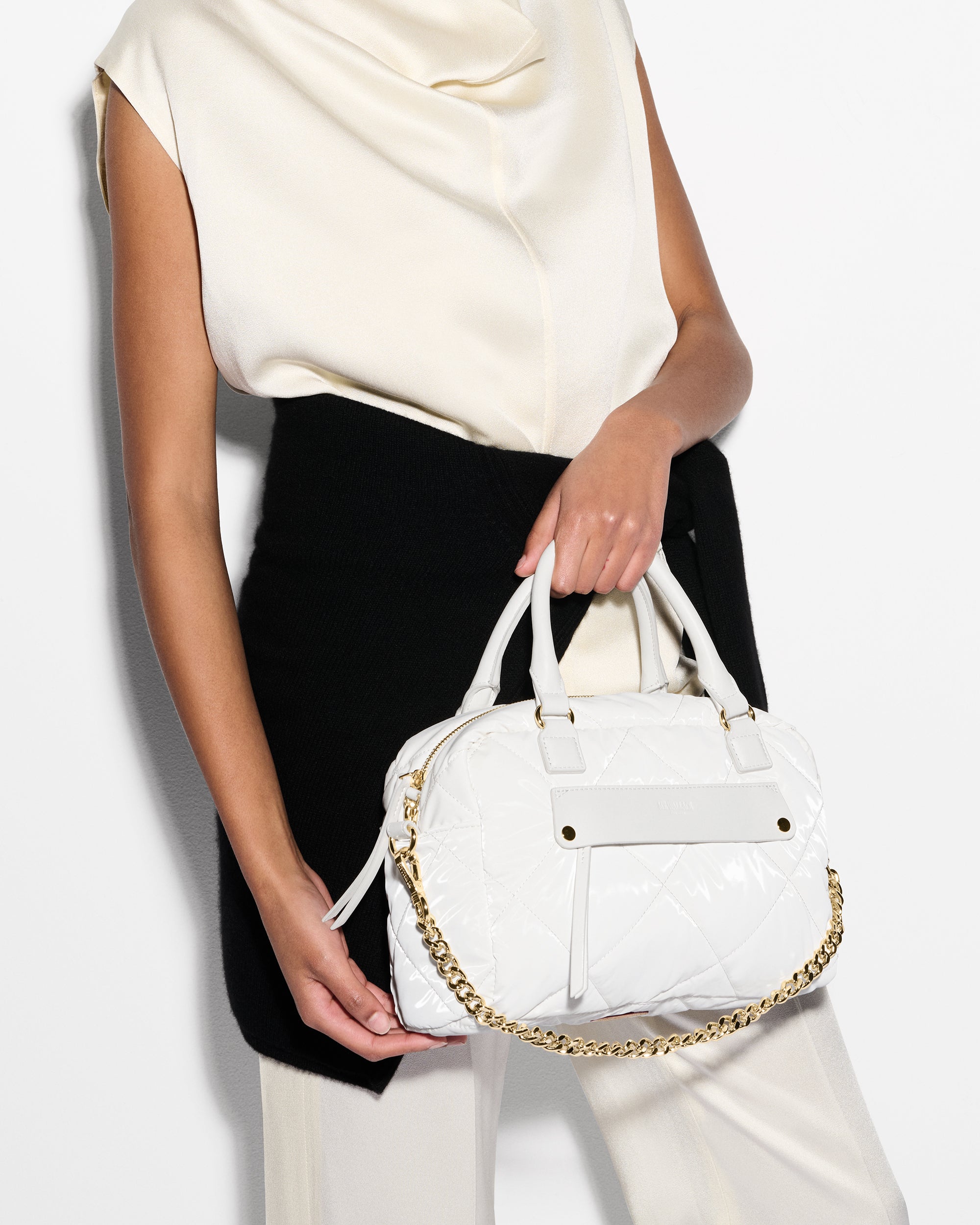 Woman holding MZ Wallace White Designer Handbag