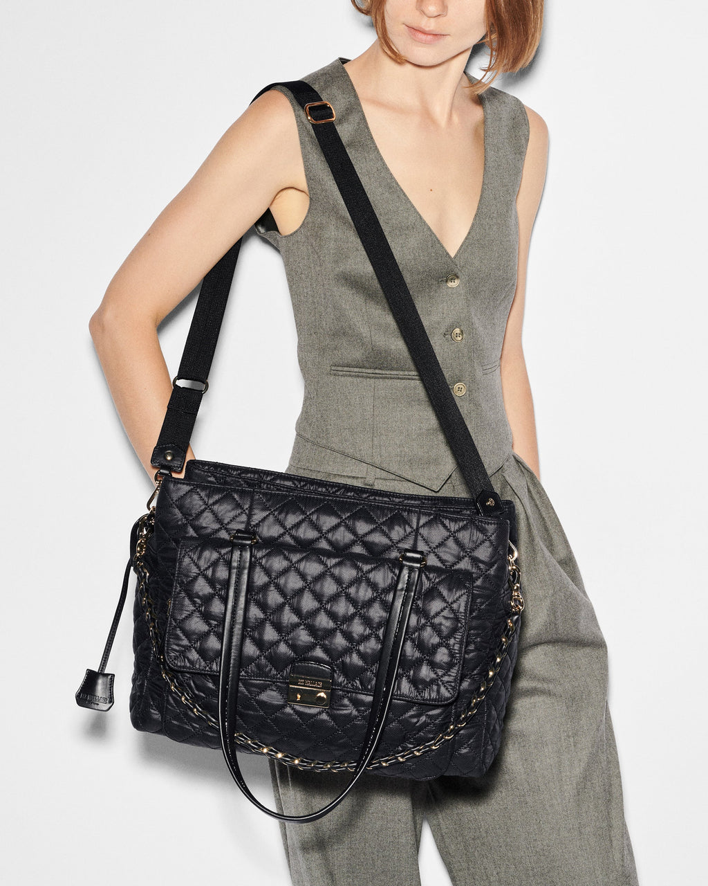 Attachable strap on woman's shoulder for the MZ Wallace Black Structured Work Bag