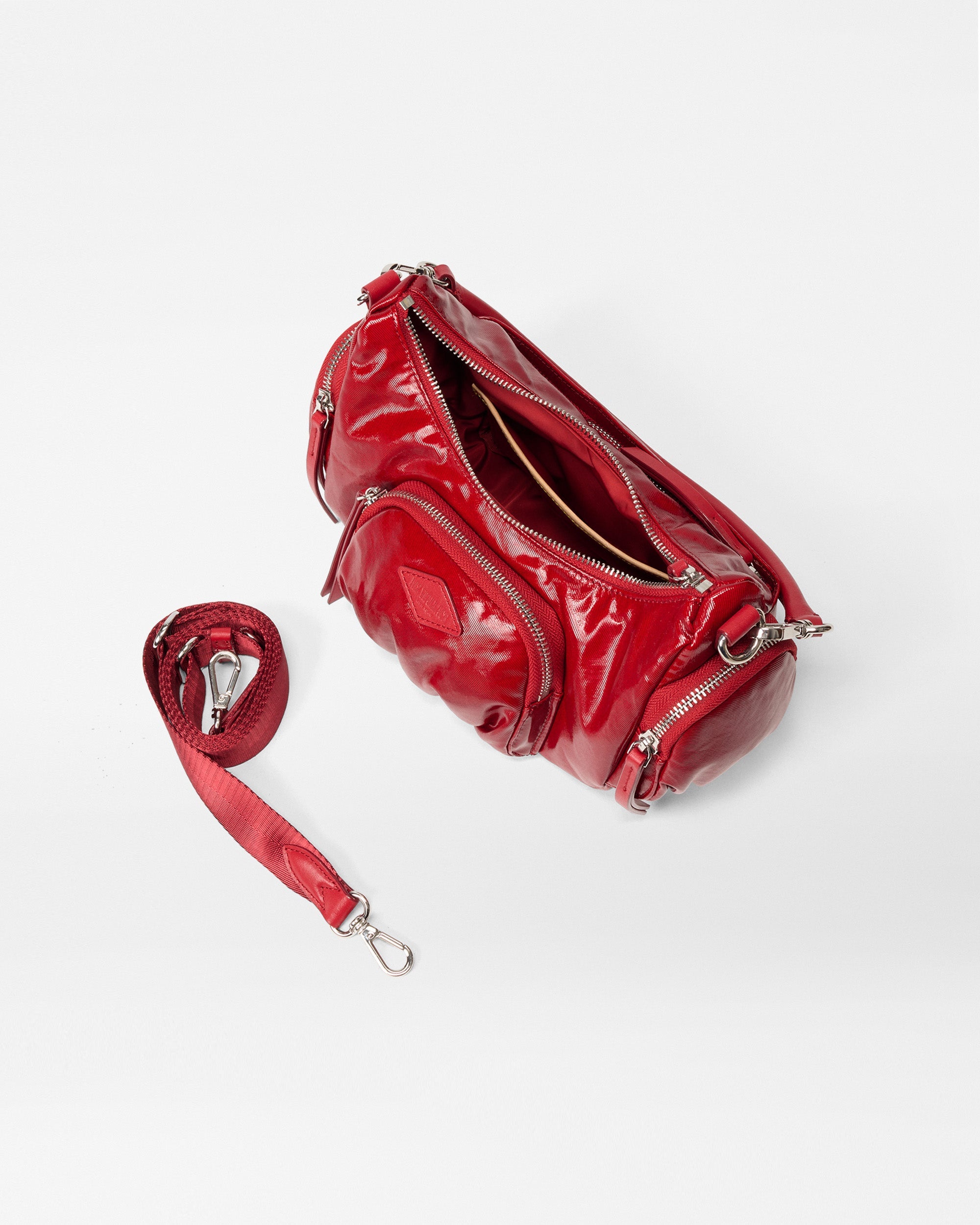 MZ Wallace Small Red Shoulder Bag opened with crossbody strap attachment next to it