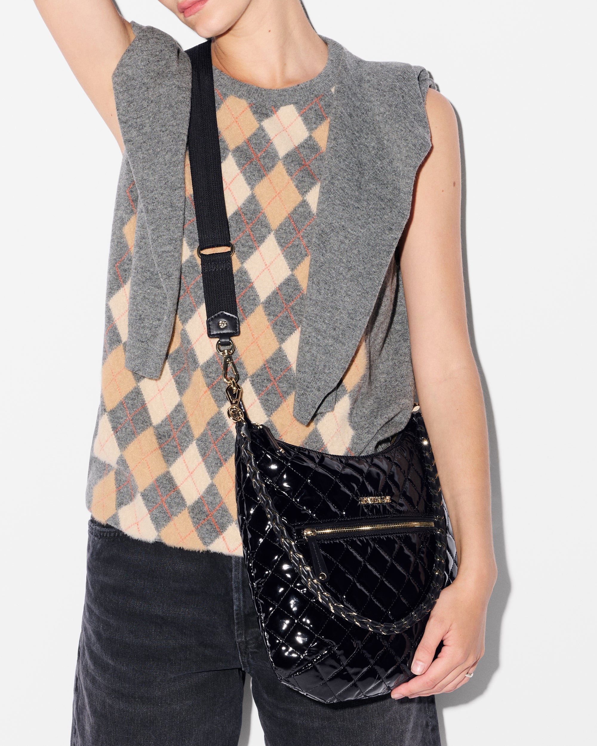 Woman wearing MZ Wallace Black Glossy Shoulder Bag as crossbody