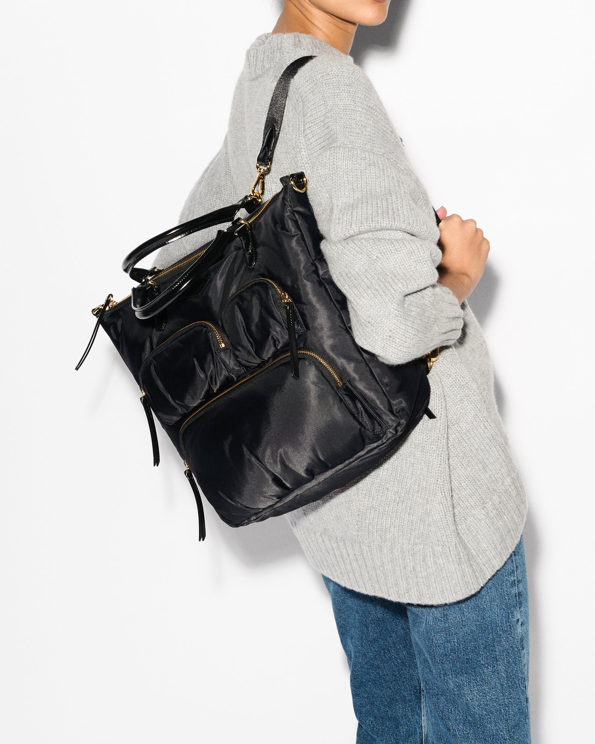MZ Wallace Stylish Black Backpack on woman's back
