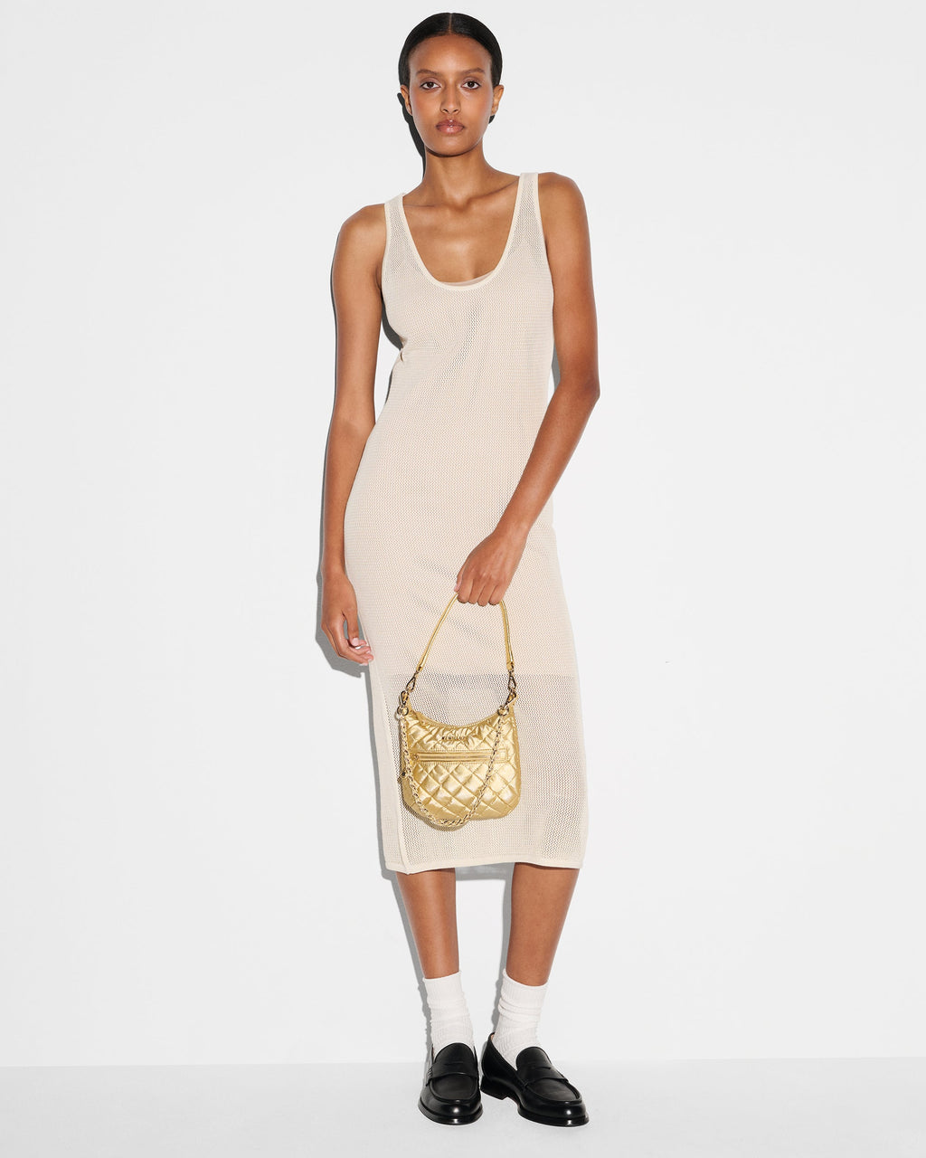 Woman holding MZ Wallace Gold Shoulder Purse in hand