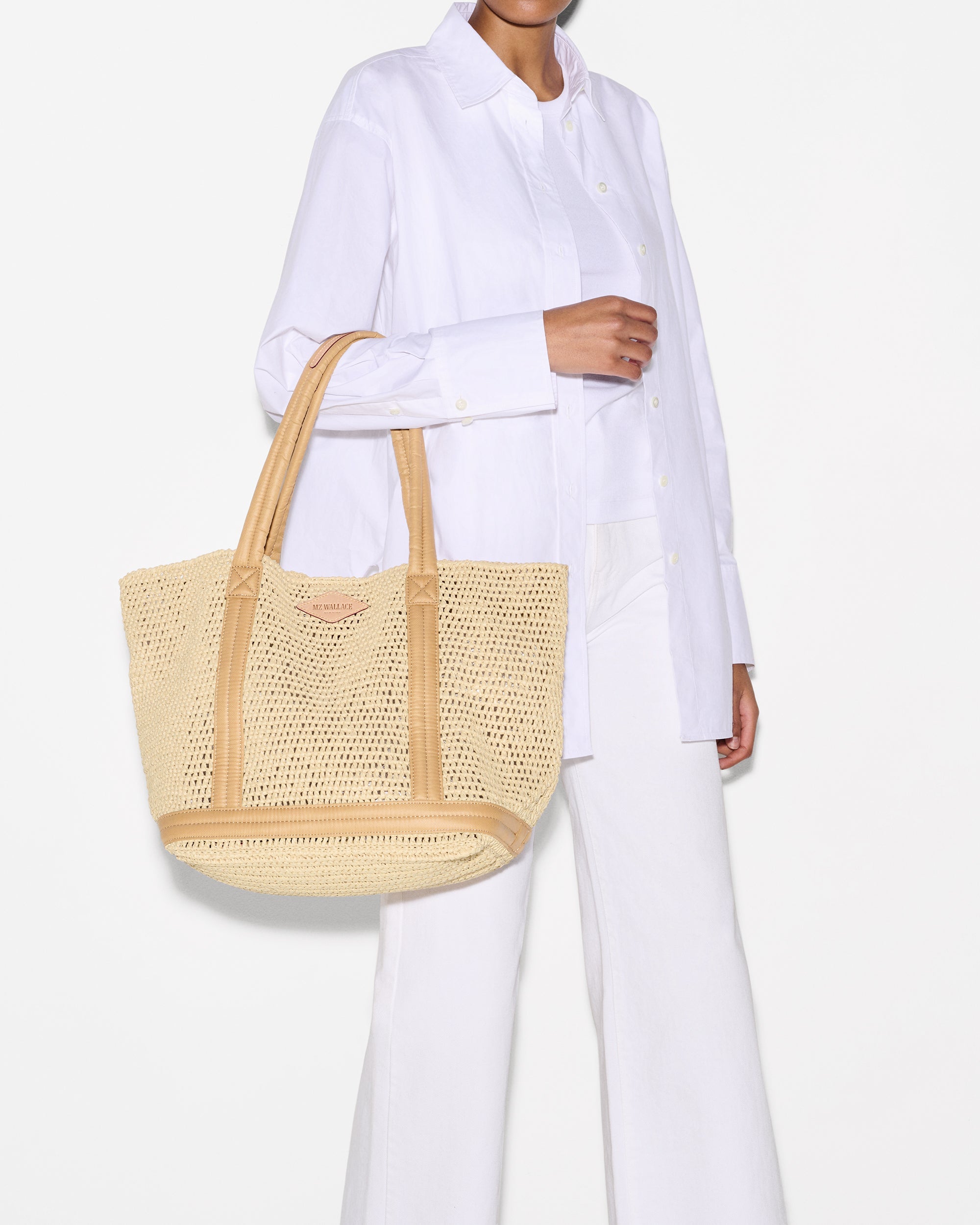 Woman holding MZ Wallace Crochet Beach Tote on arm