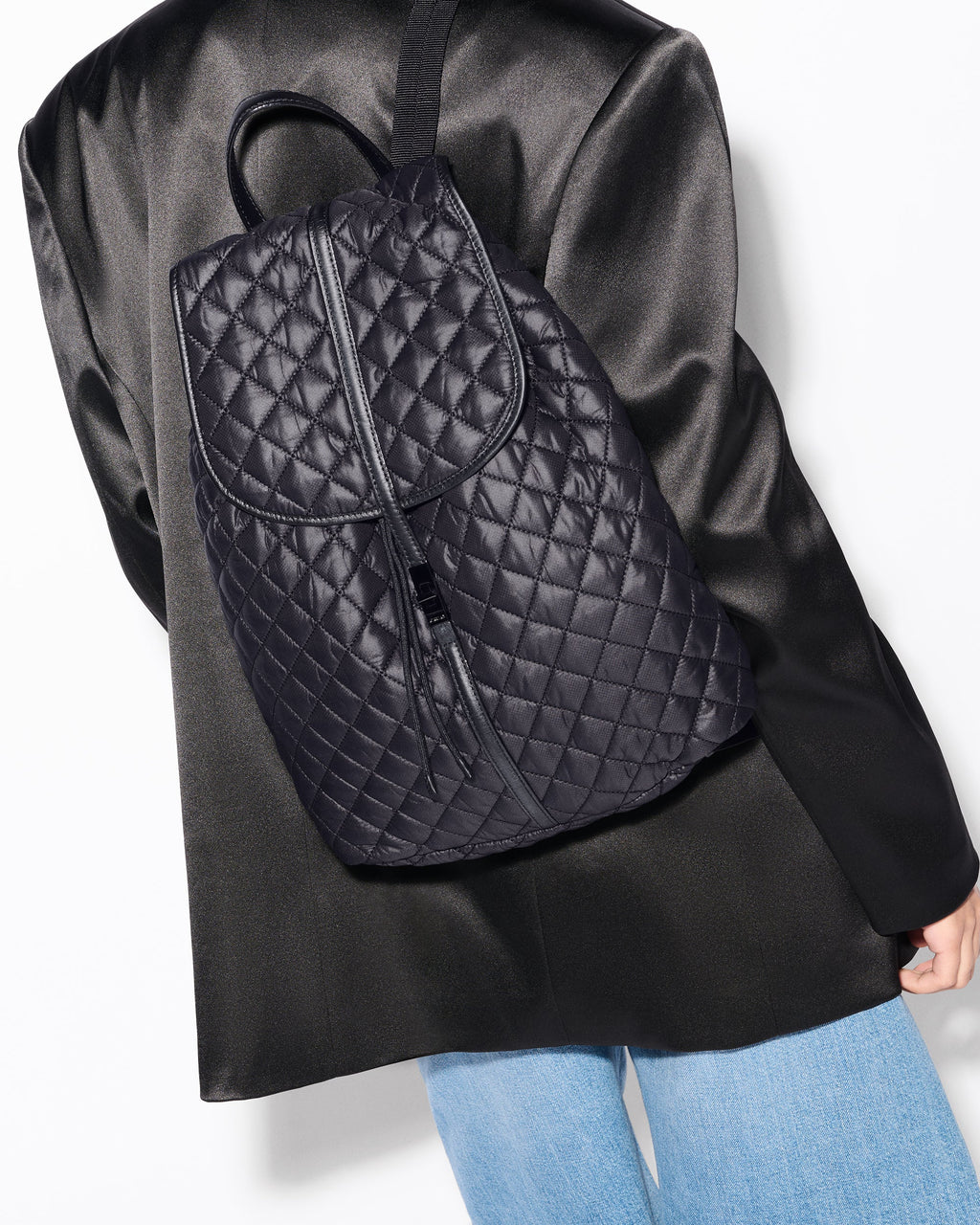 Woman wearing MZ Wallace Black Spacious Backpack on back