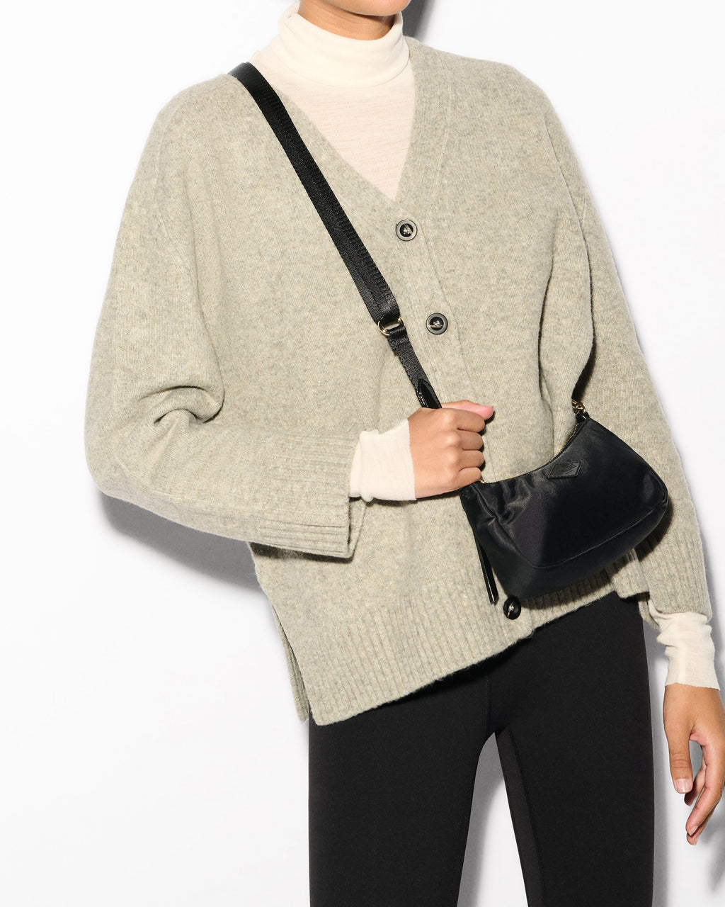 MZ Wallace Black Mini Shoulder Bag across woman's body for crossbody wear