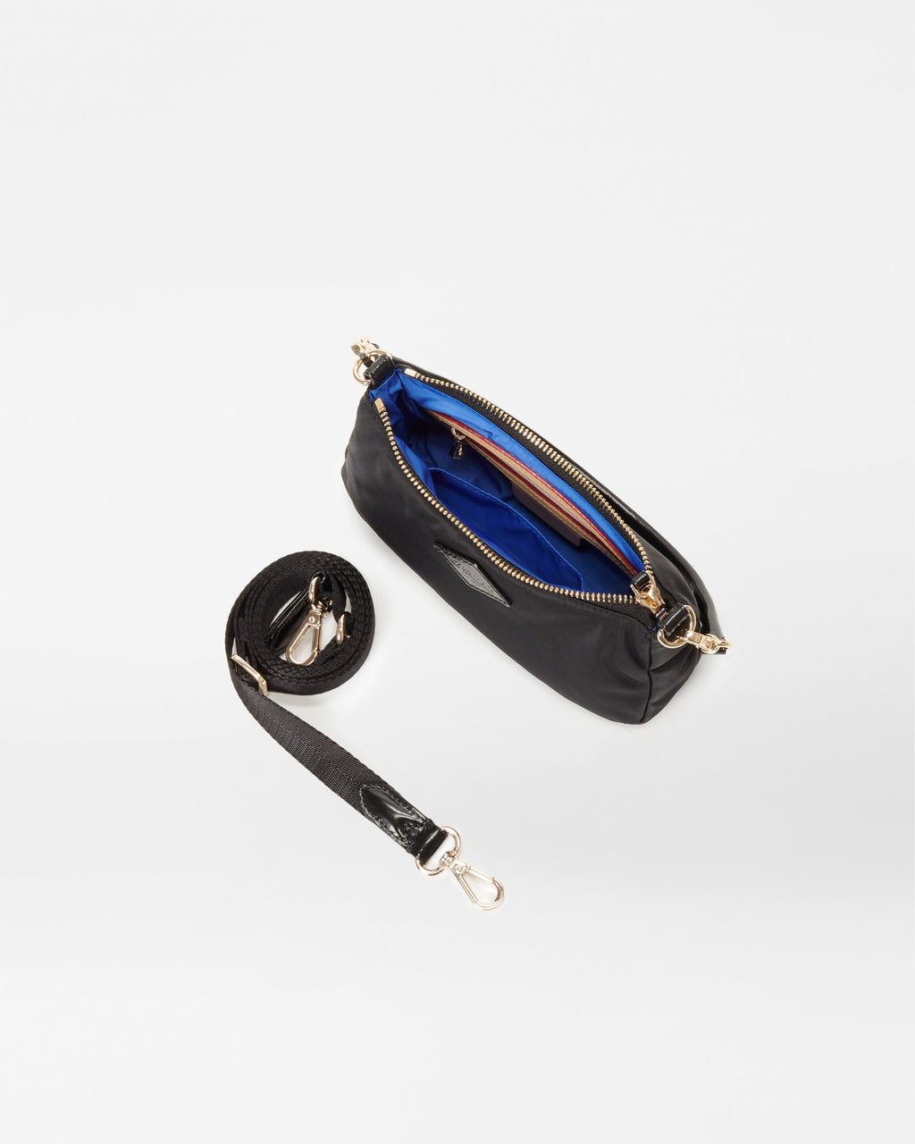 MZ Wallace Black Mini Shoulder Bag opened with crossbody strap accessory next to it