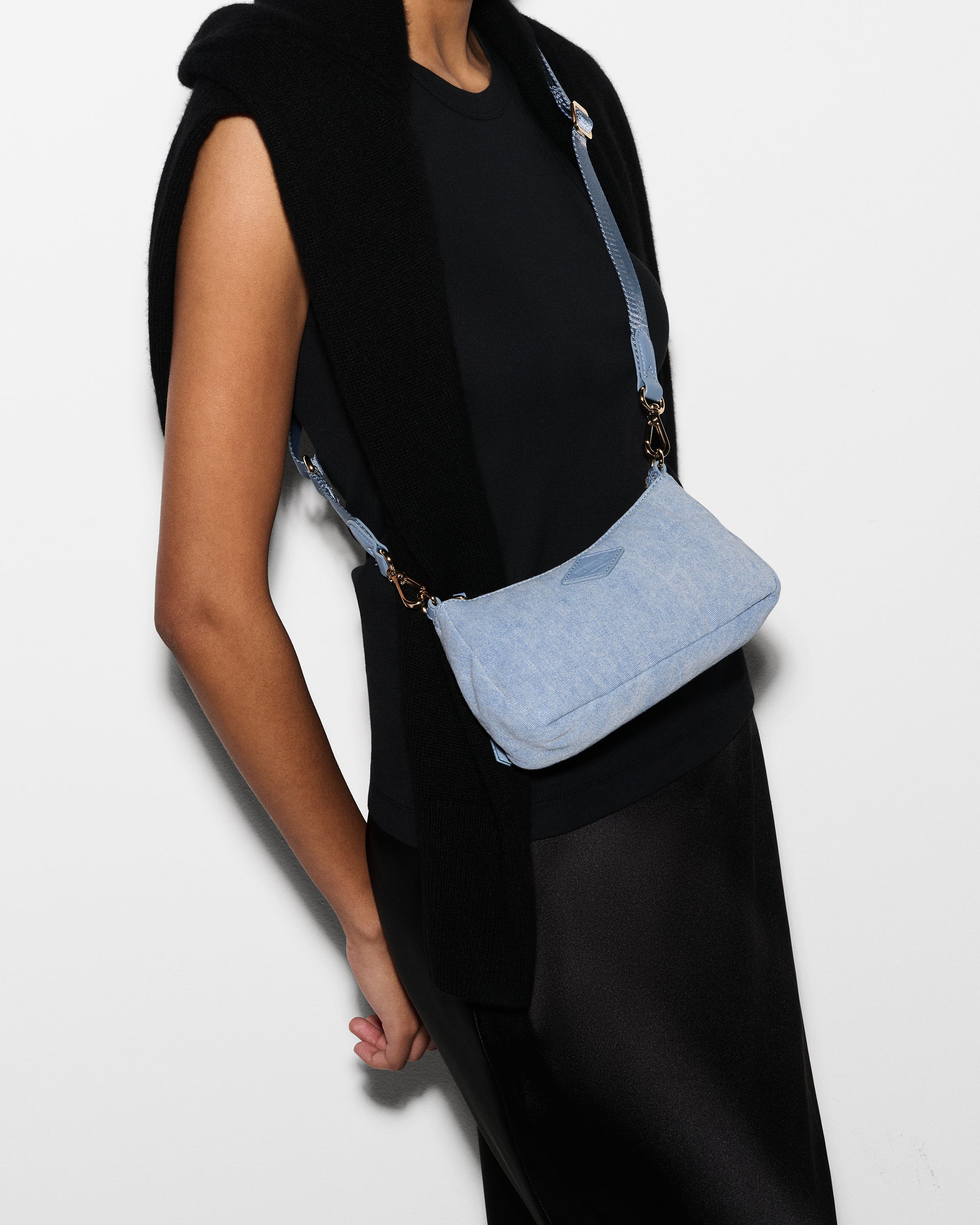 Woman wearing MZ Wallace Denim Blue Purse as crossbody