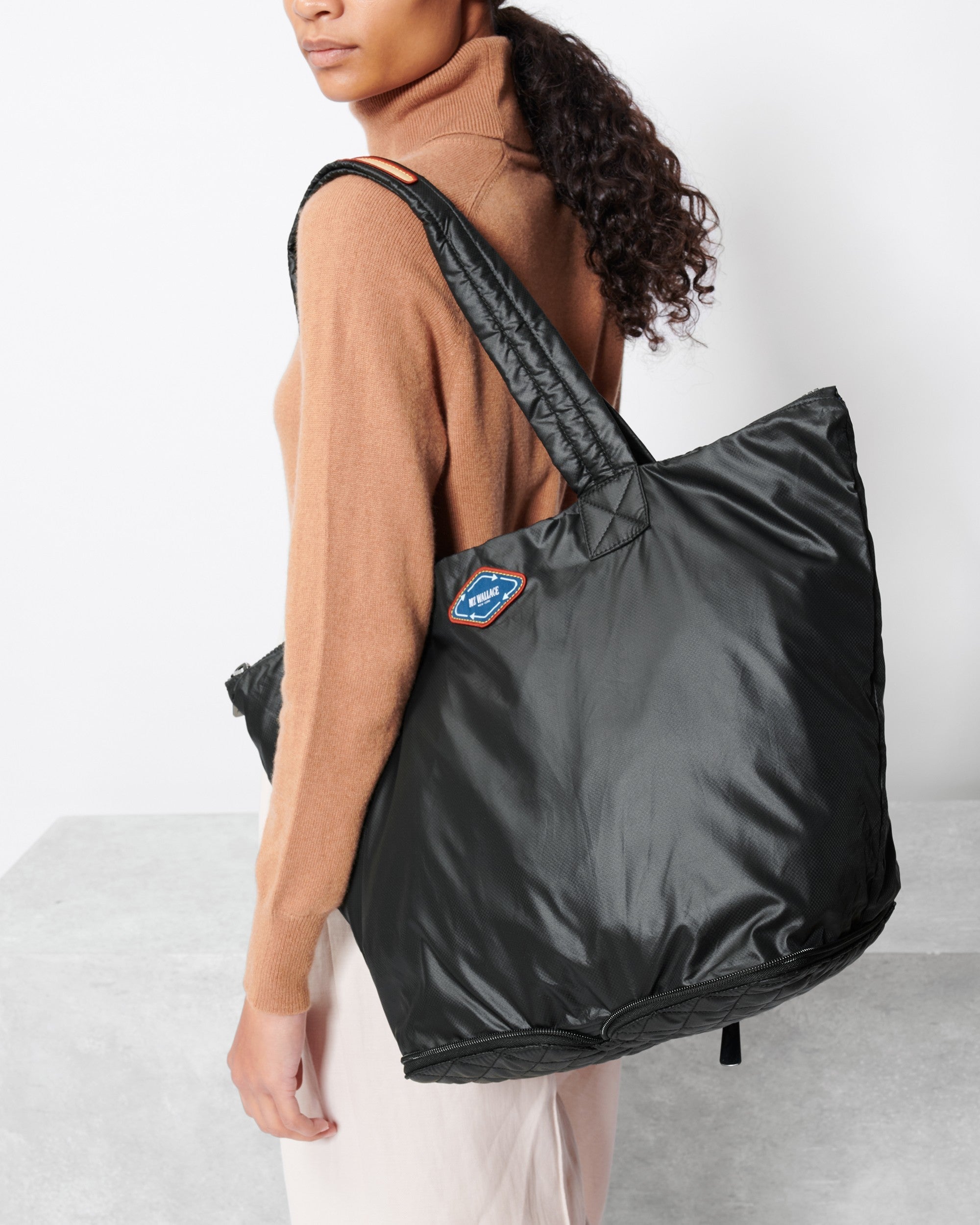 Woman holding MZ Wallace Sustainable Tote Bag on her shoulder